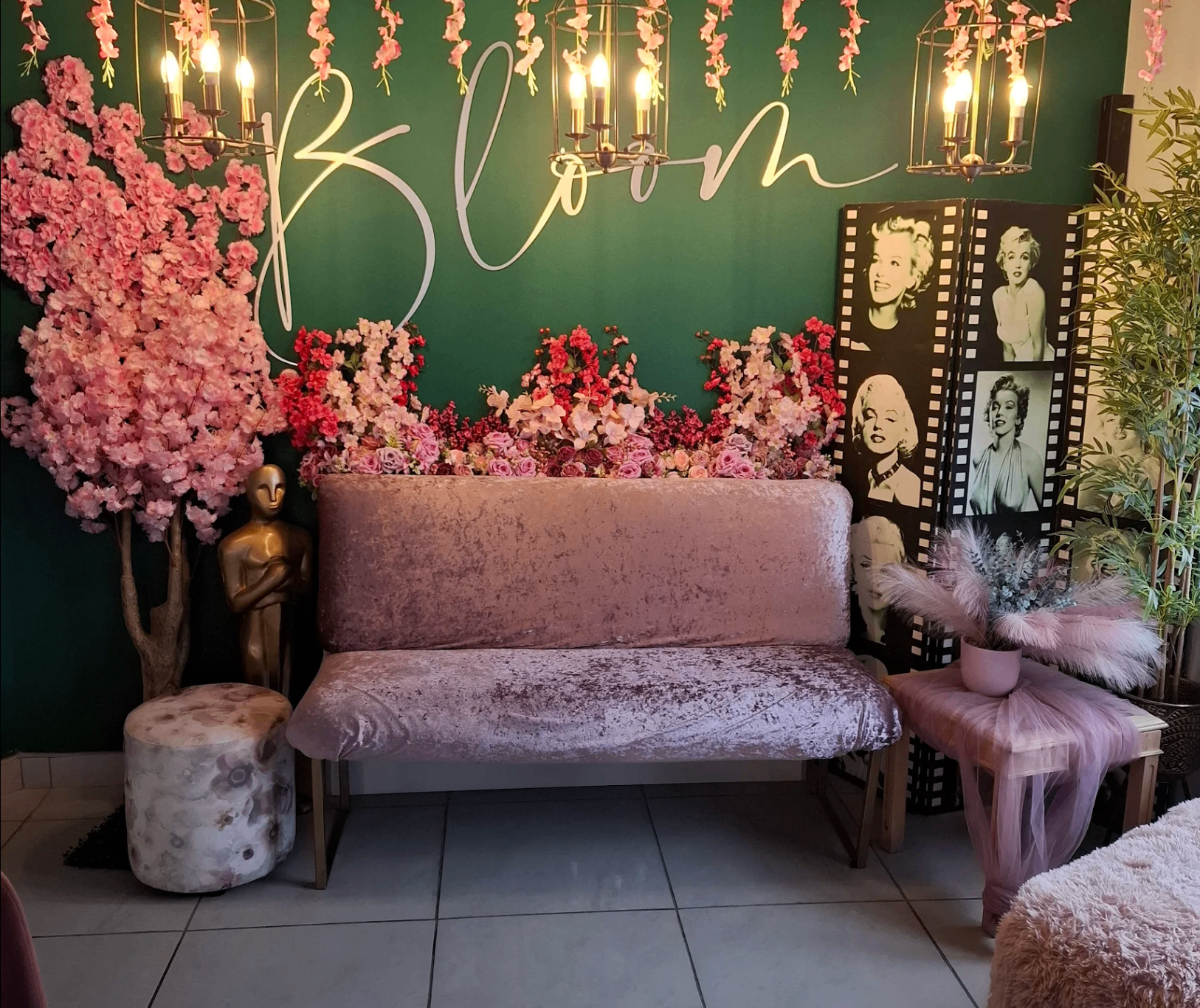 Green feature wall at The Bloom Café with cursive Bloom sign